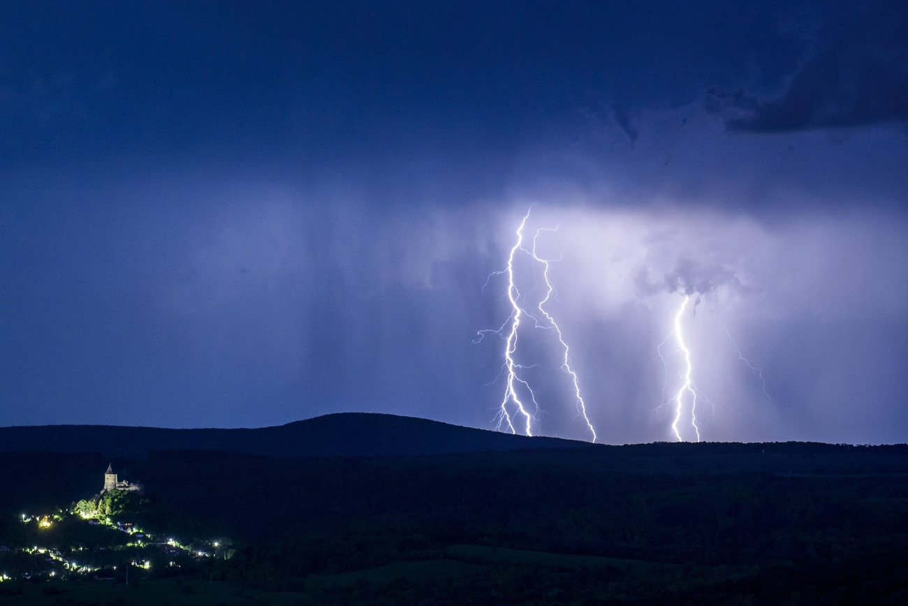 lightning bolts over a dark landscape