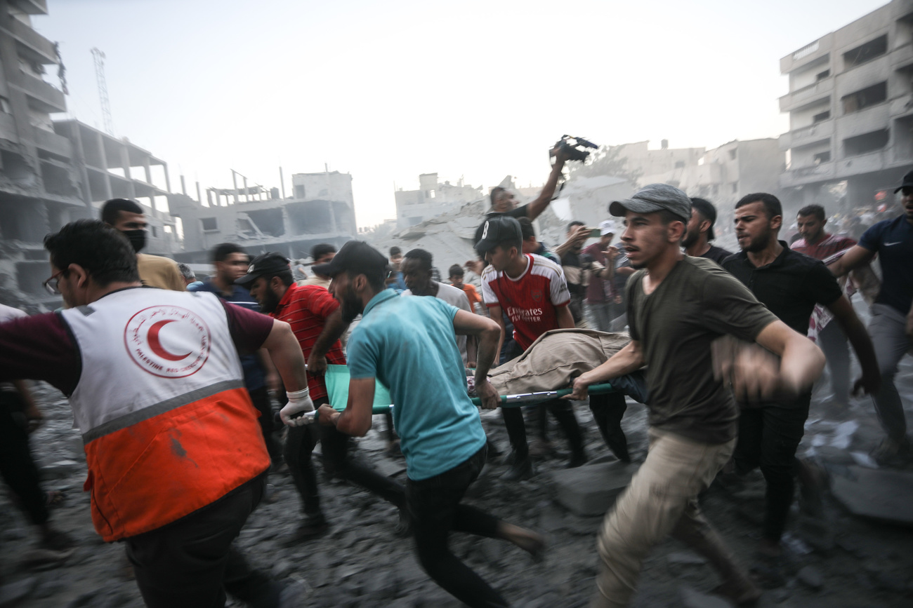 Palestinians stretcher an injured man following an Israeli strike on building in Rafah in the southern Gaza Strip