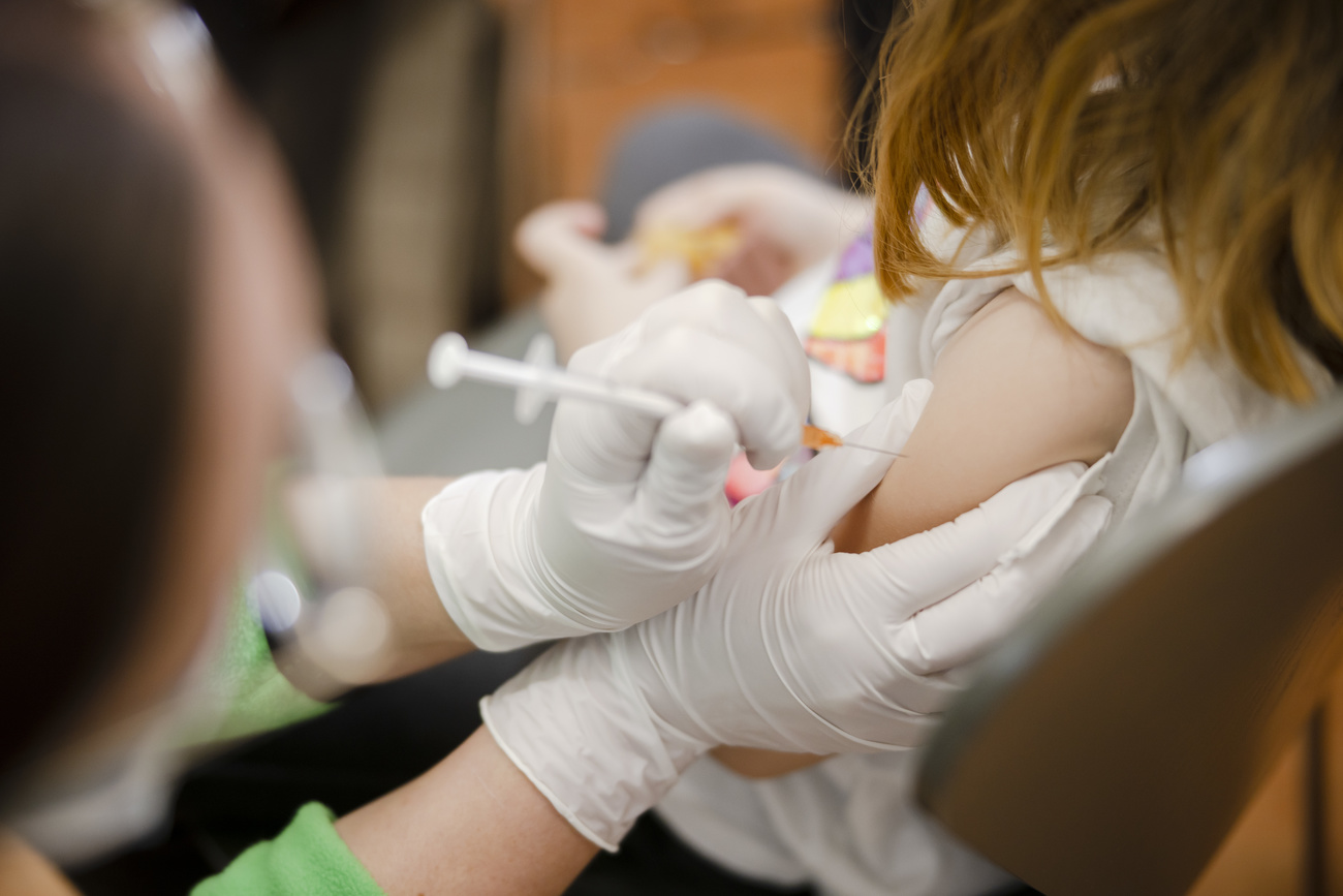 Young child being administered a vaccine in the arm