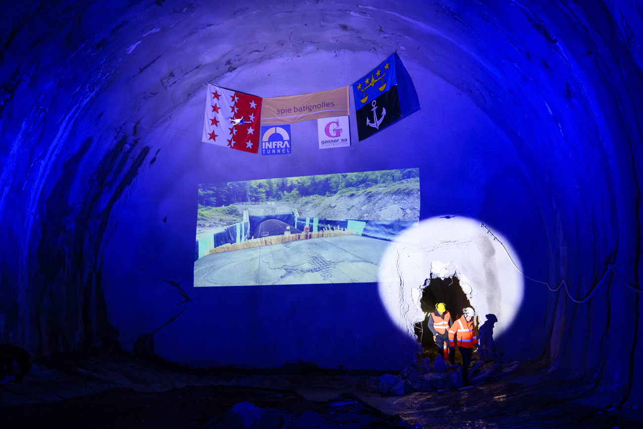 Workers pass through the junction hole of the Les Evouettes tunnel