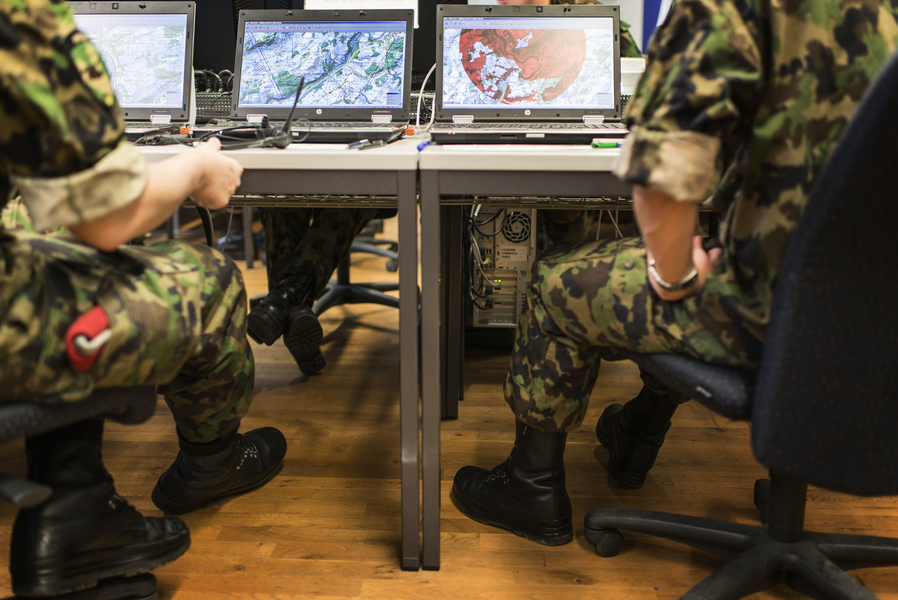 Swiss army personnel in front of computers