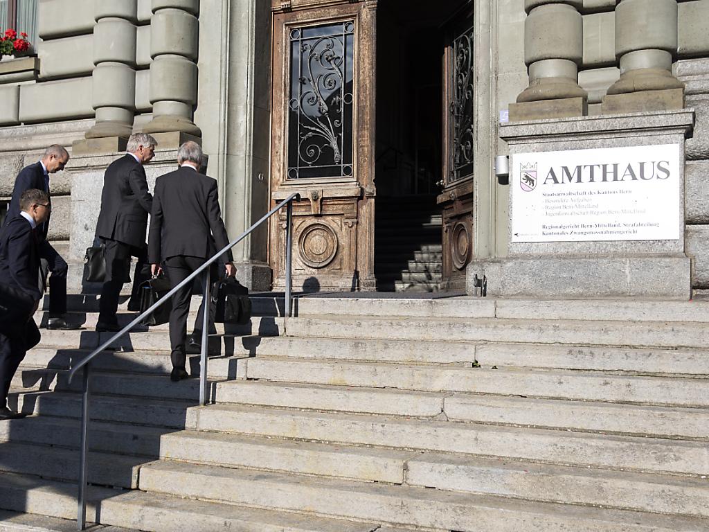 Herren und Anzug und mit Aktentaschen, die eine Treppe ins Gerichtsgebäude hochgehen