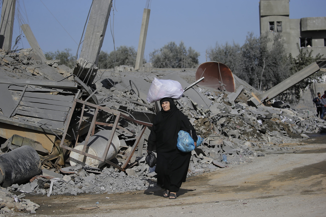 Palestinian woman in rubble