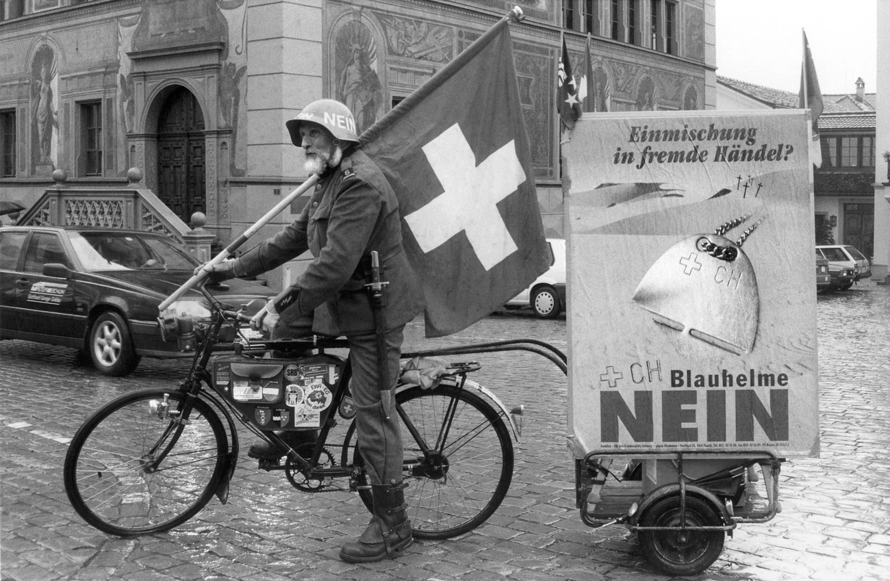 Man on bicycle blue helmet vote Switzerland 1994