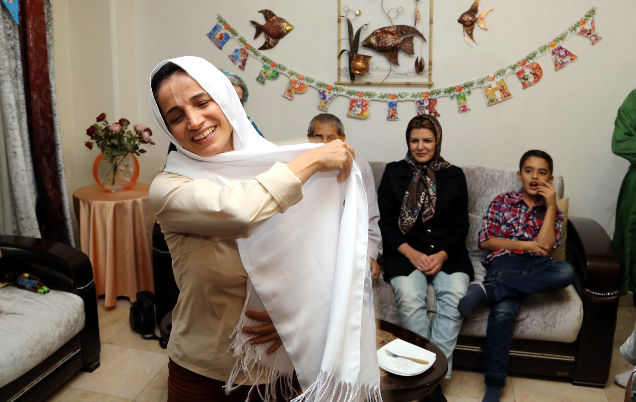 Picture of Iranian activist Nasrin Sotoudeh in her house with family in the back.