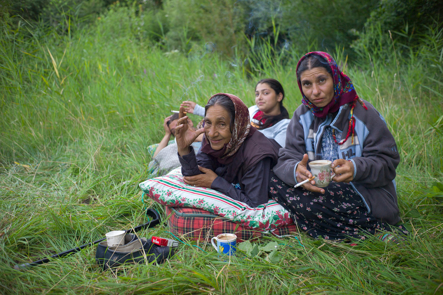 Three women sitting on grass