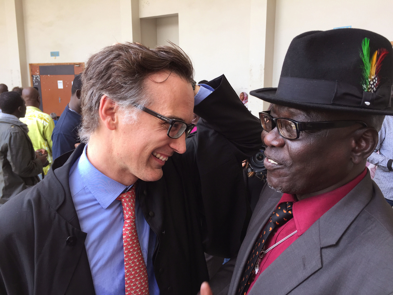 Swiss lawyer Alain Werner (left) talks to former Chad prisoner Souleymane Guengueng