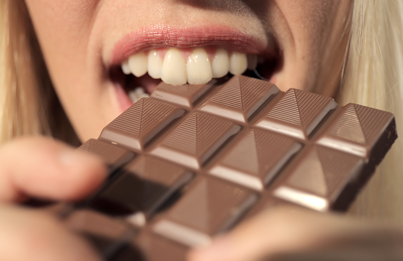 Picture of a woman biting a chocolate bar
