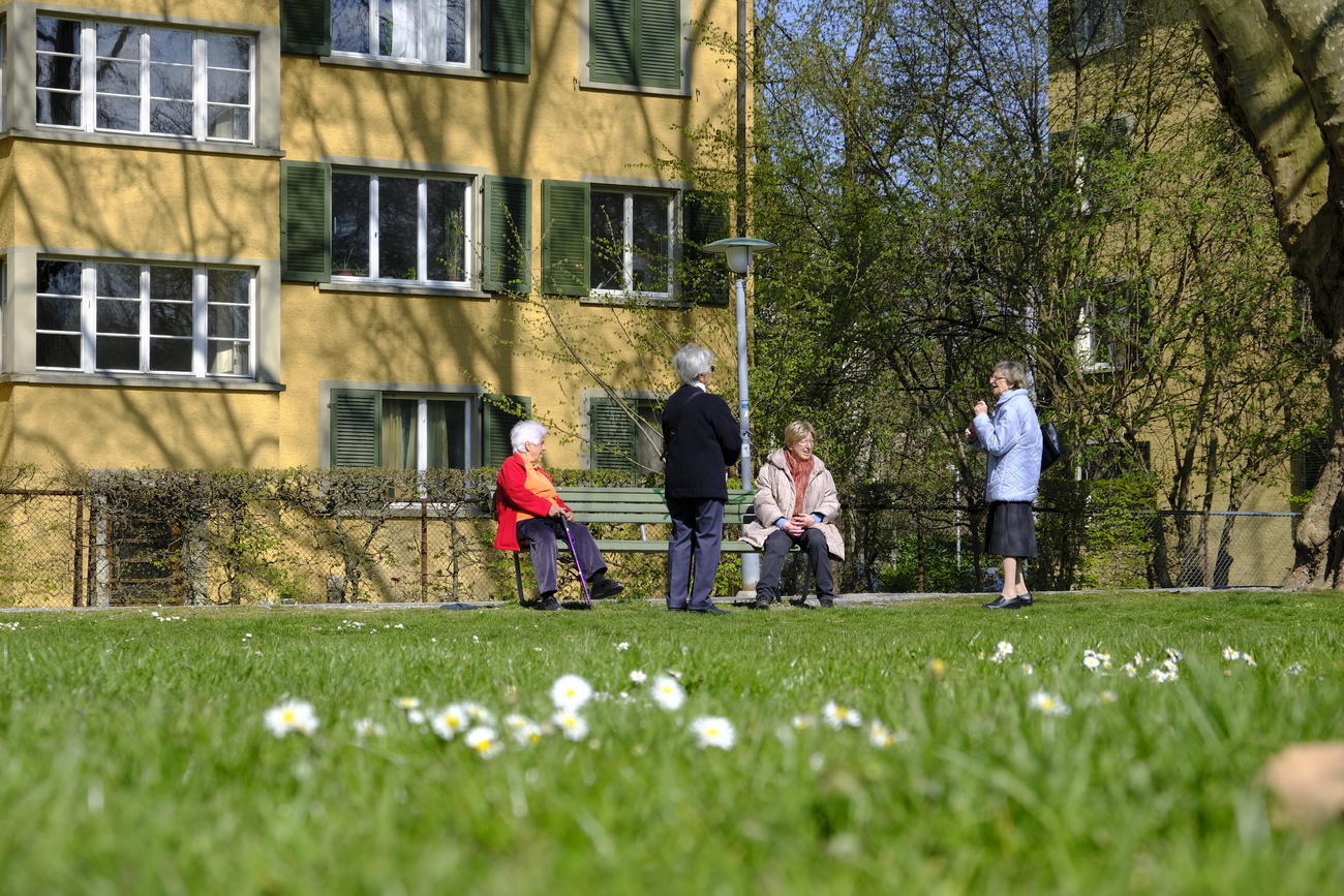Quatre personnes âgées près d un banc dans un parc