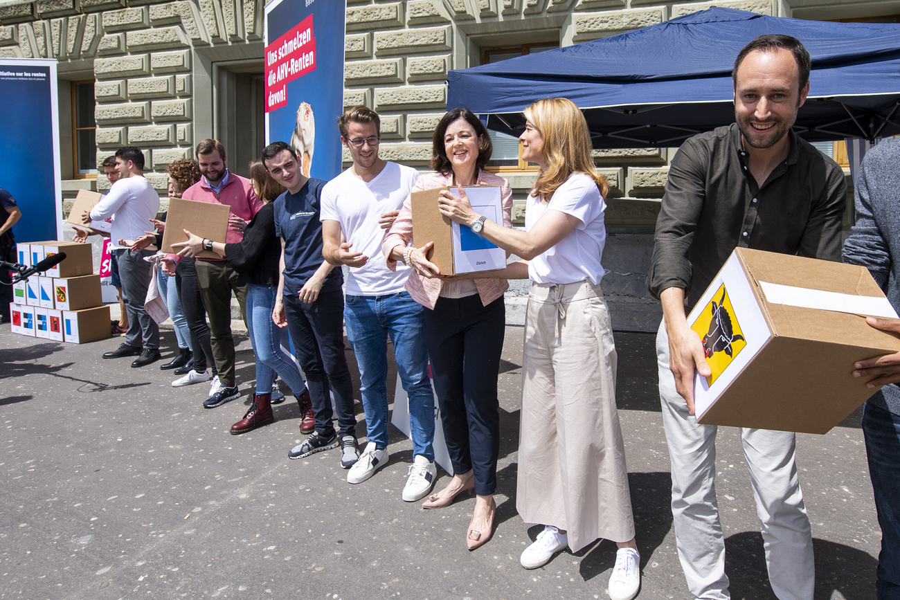 un gruppo di persone consegna le scatole contenenti le firme per l iniziativa