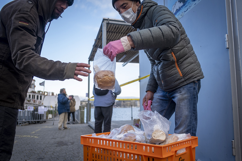 A man receives a food handout in Geneva