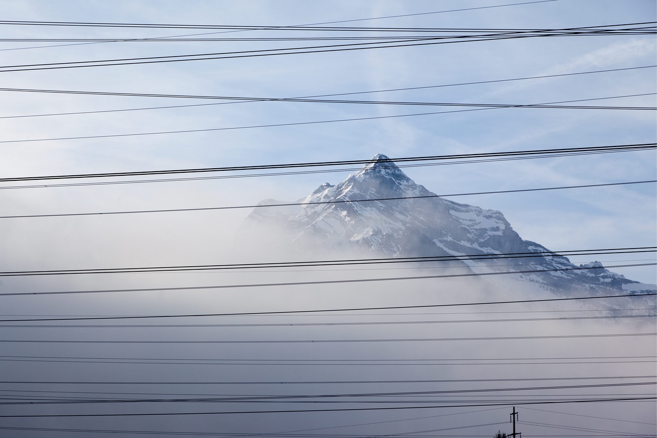 fils électriques devant une montagne suisse