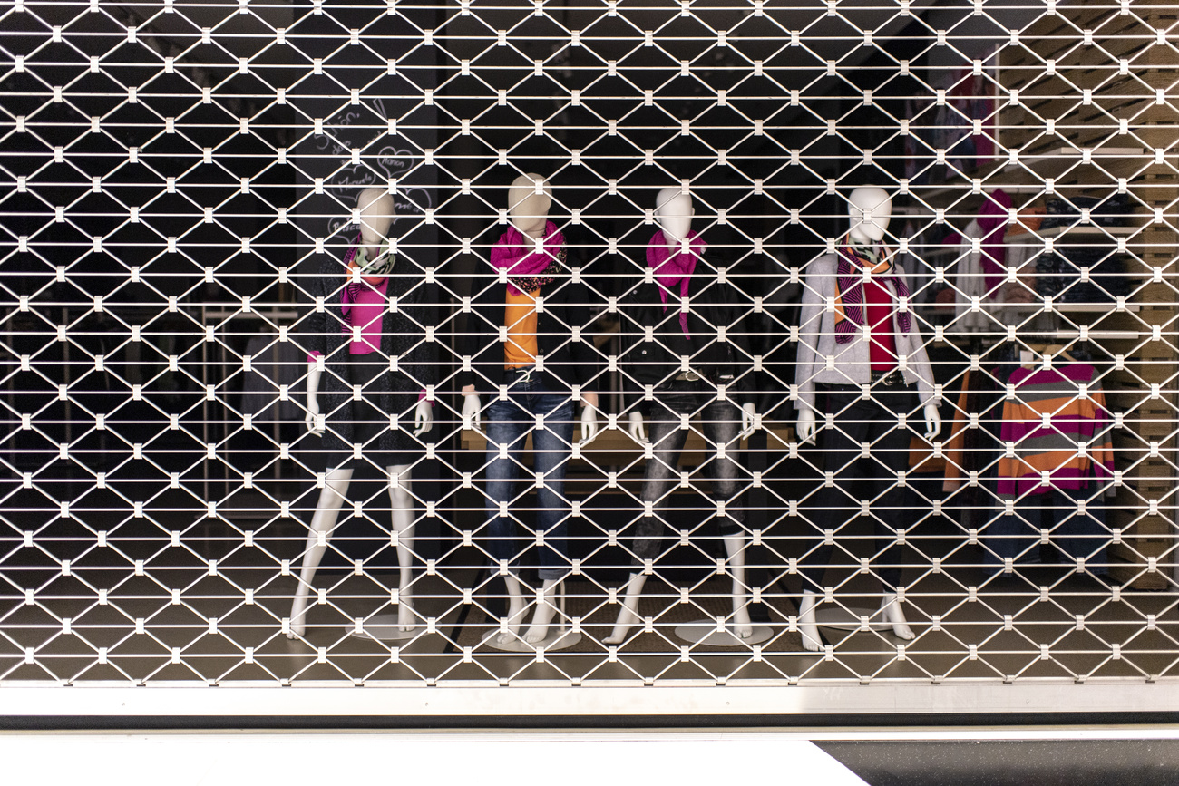 Shuttered shop front with mannequins