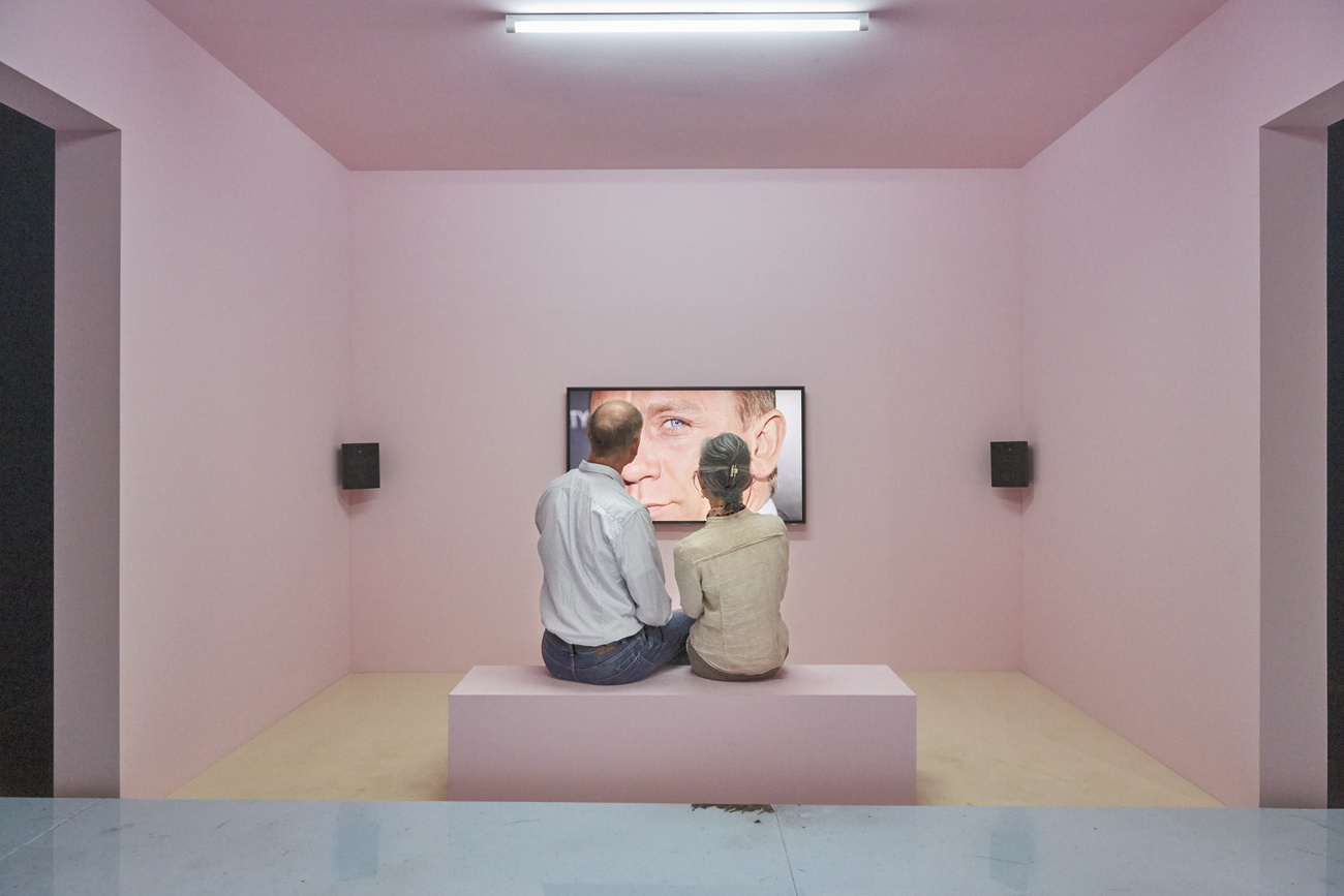 two people sitting in front of an artwork