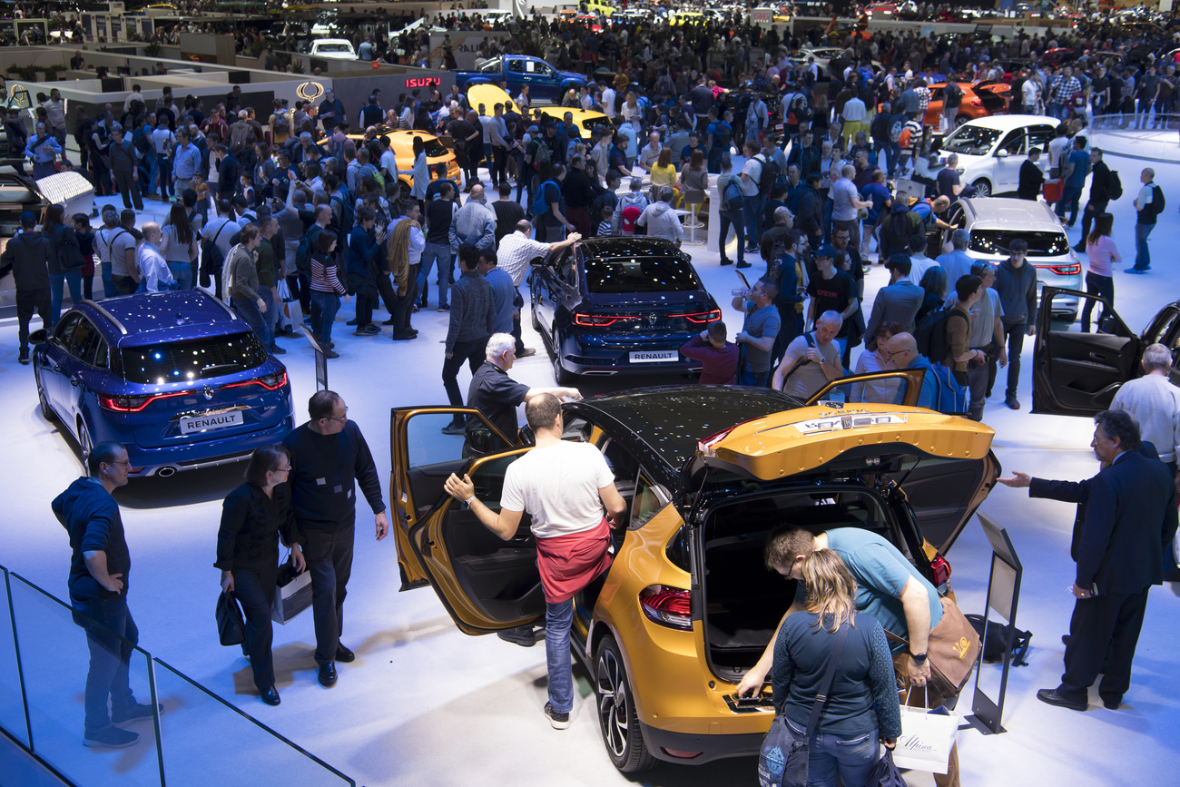 Visitors attend the 89th Geneva International Motor Show on March 16, 2019.