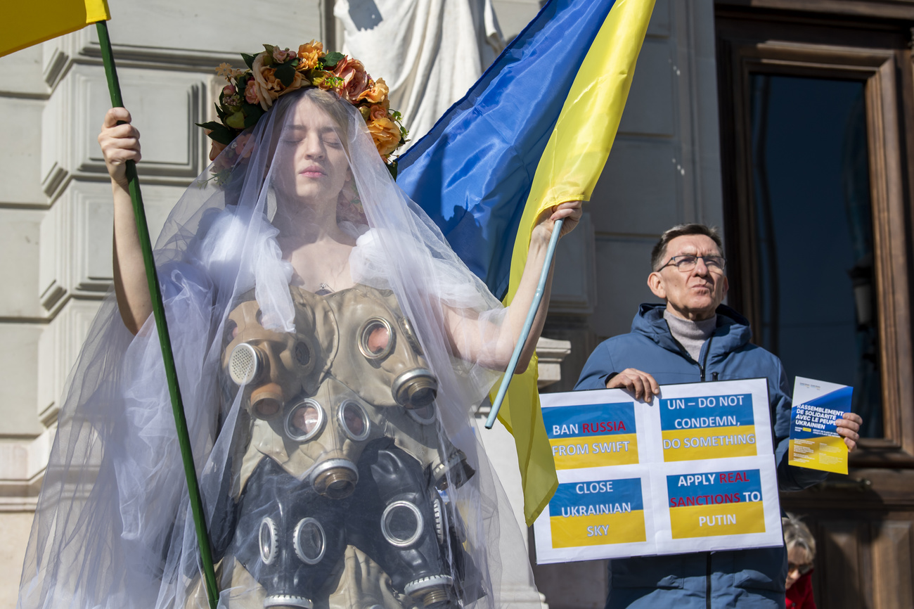 A protester wears a dress made from gas masks during a demonstration against the Russian invasion of Ukraine in Geneva, Switzerland.