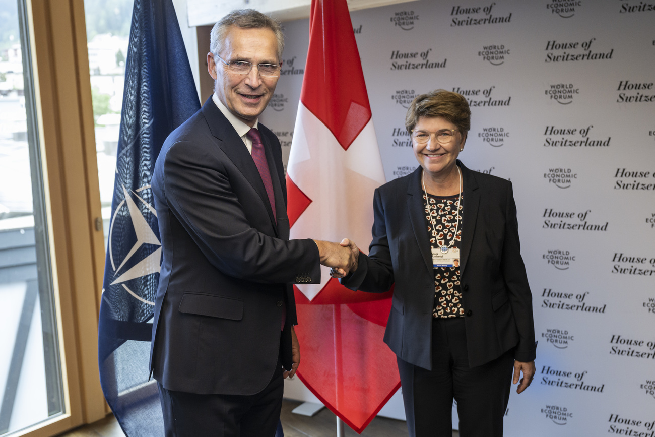 a man and a woman in suits, shaking hands