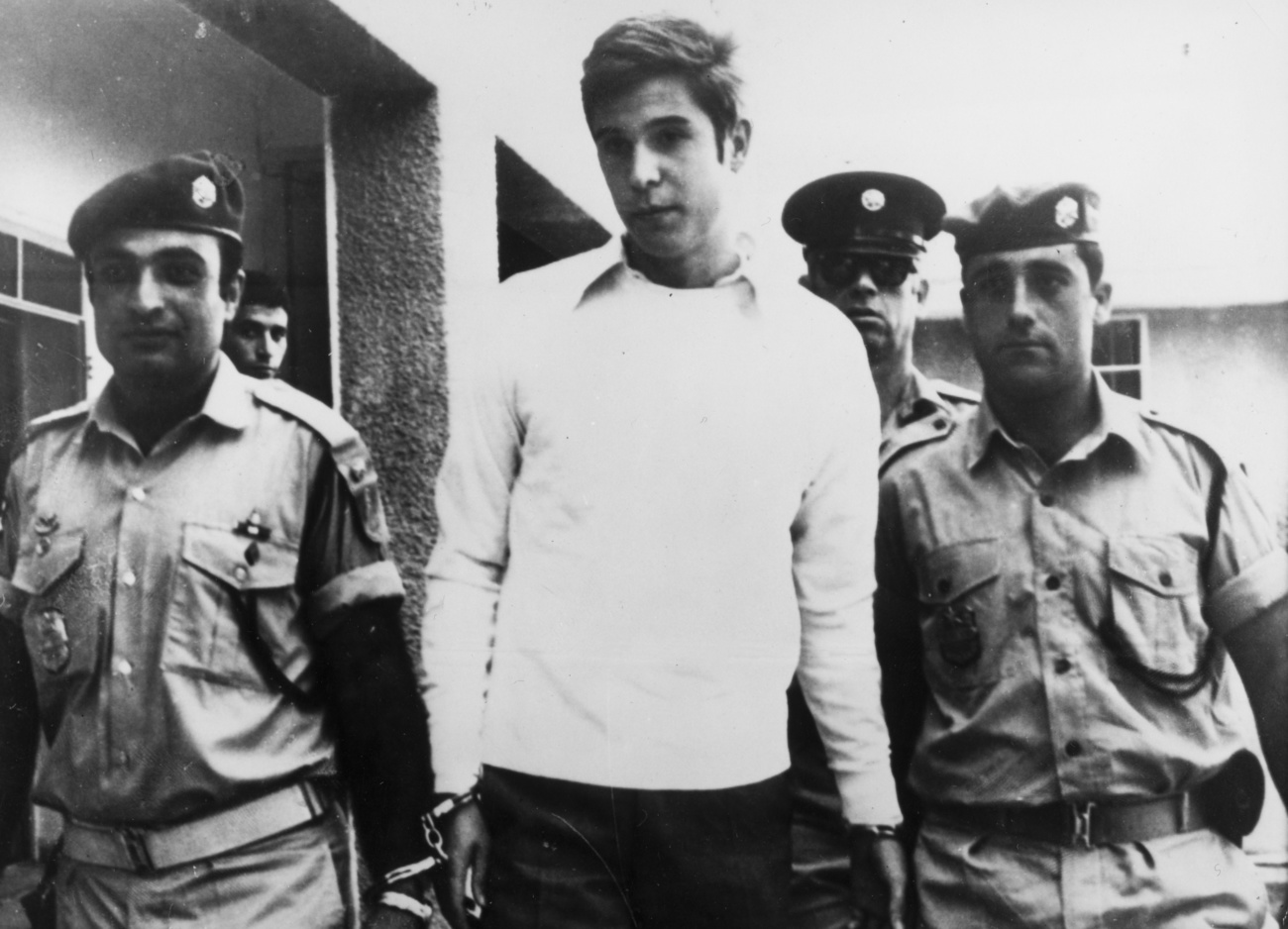Bruno Breguet escorted by two Israeli policemen after his arrest in Tel Aviv