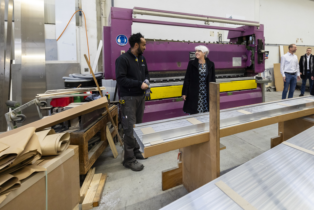 Elisabeth Baume-Schneider, right, speaks to Major Tesfay, an employee of the Liechtblick workshop, an asylum integration centre for refugees on Thursday, November 30, 2023.