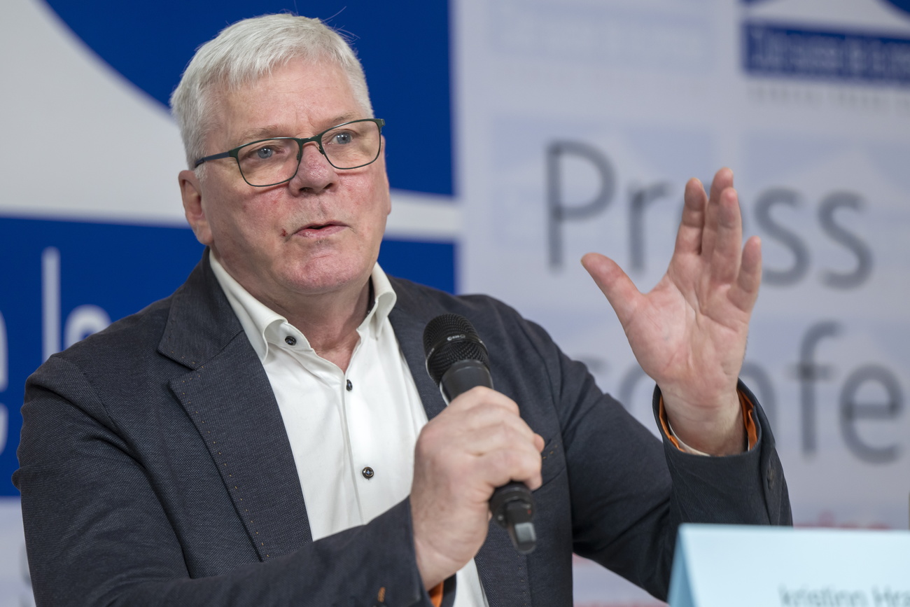 man talking at a press conference