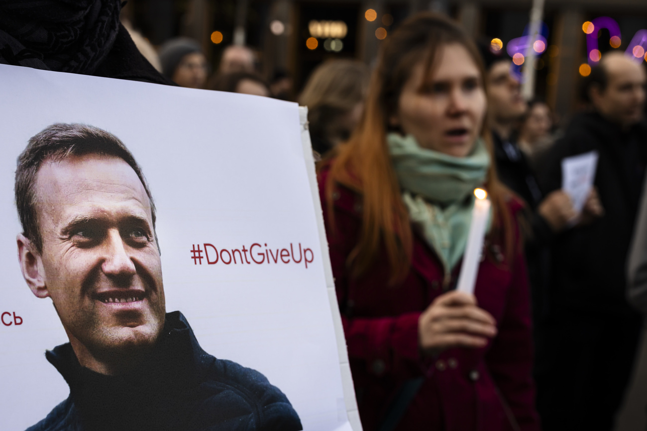 Participants at a memorial for Russian opposition politician Alexei Navalny (pictured) in Zurich on Friday
