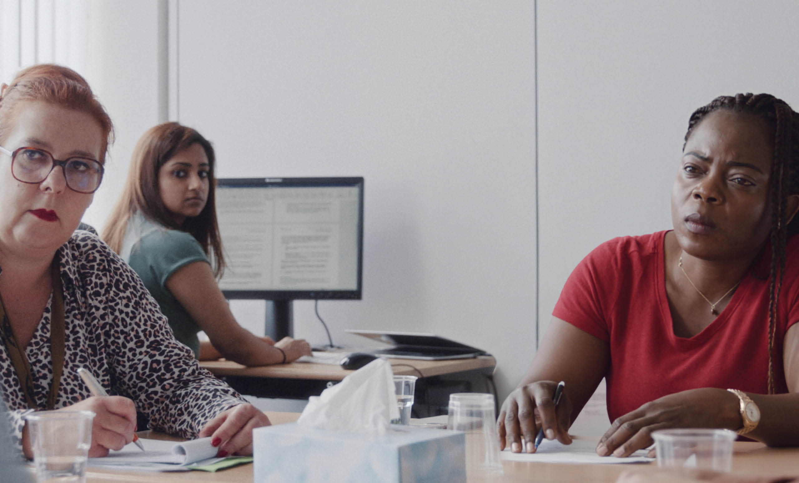 Three women in a immigration office