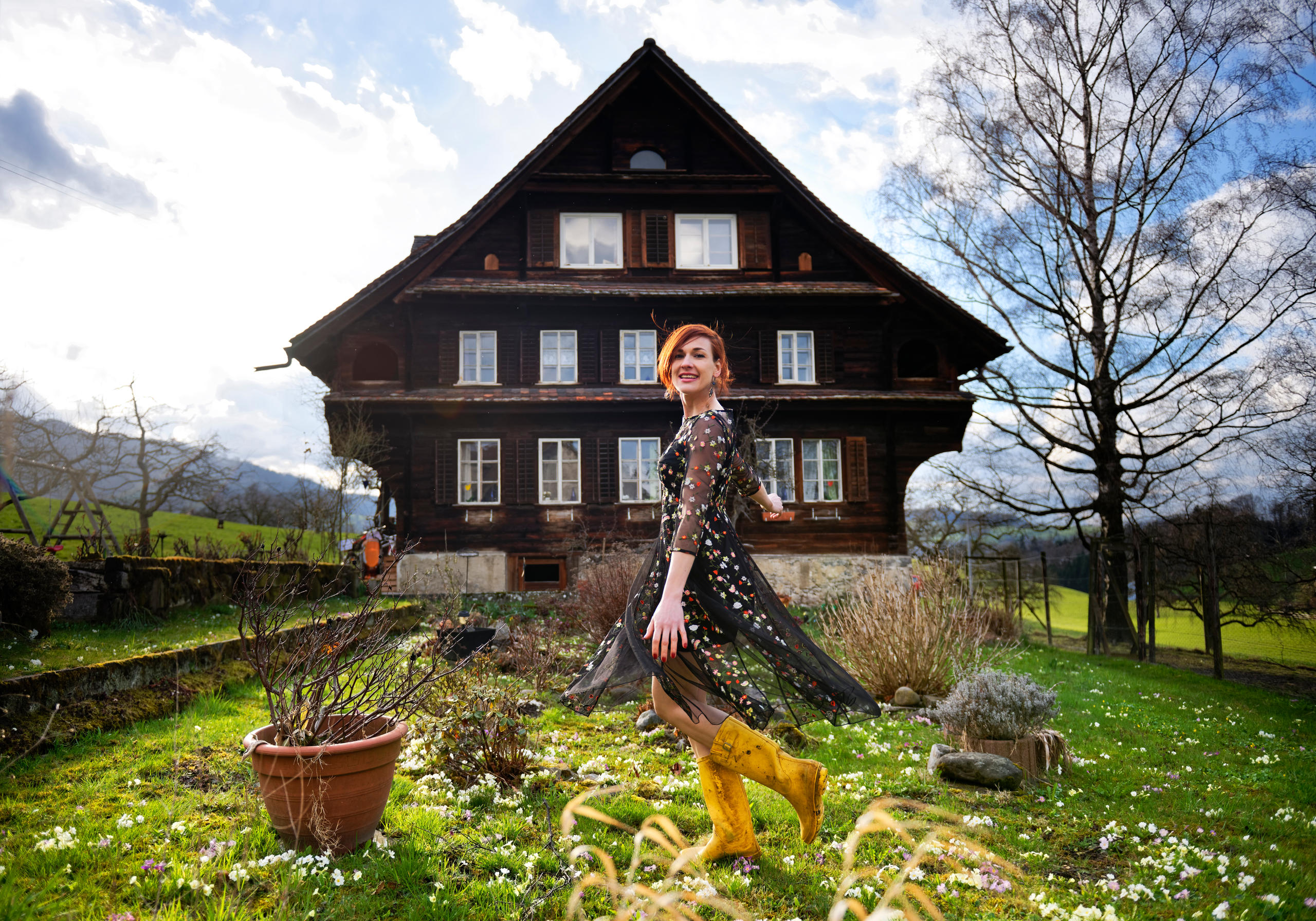 Gabriela Martina in front of the farmhouse where she grew up