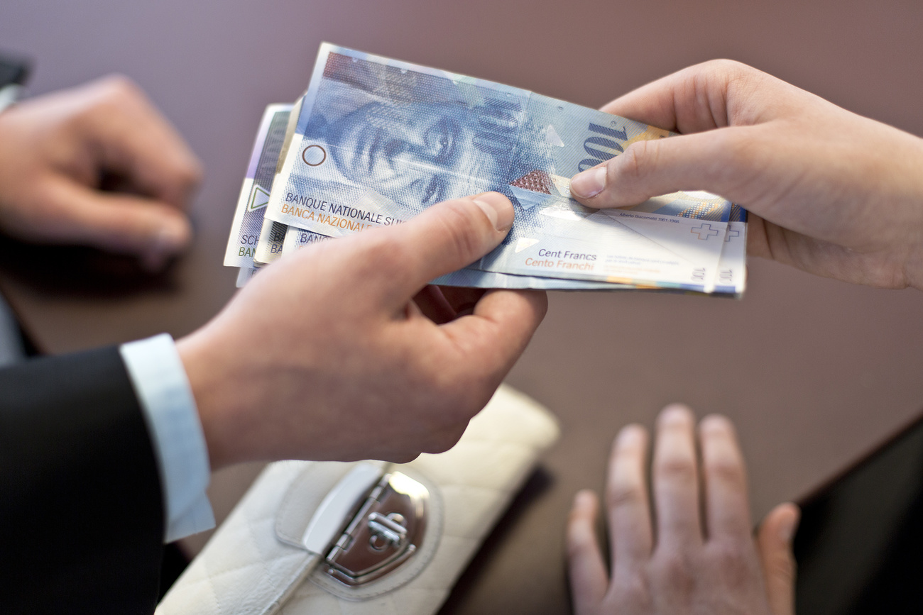 Swiss franc notes changing hands