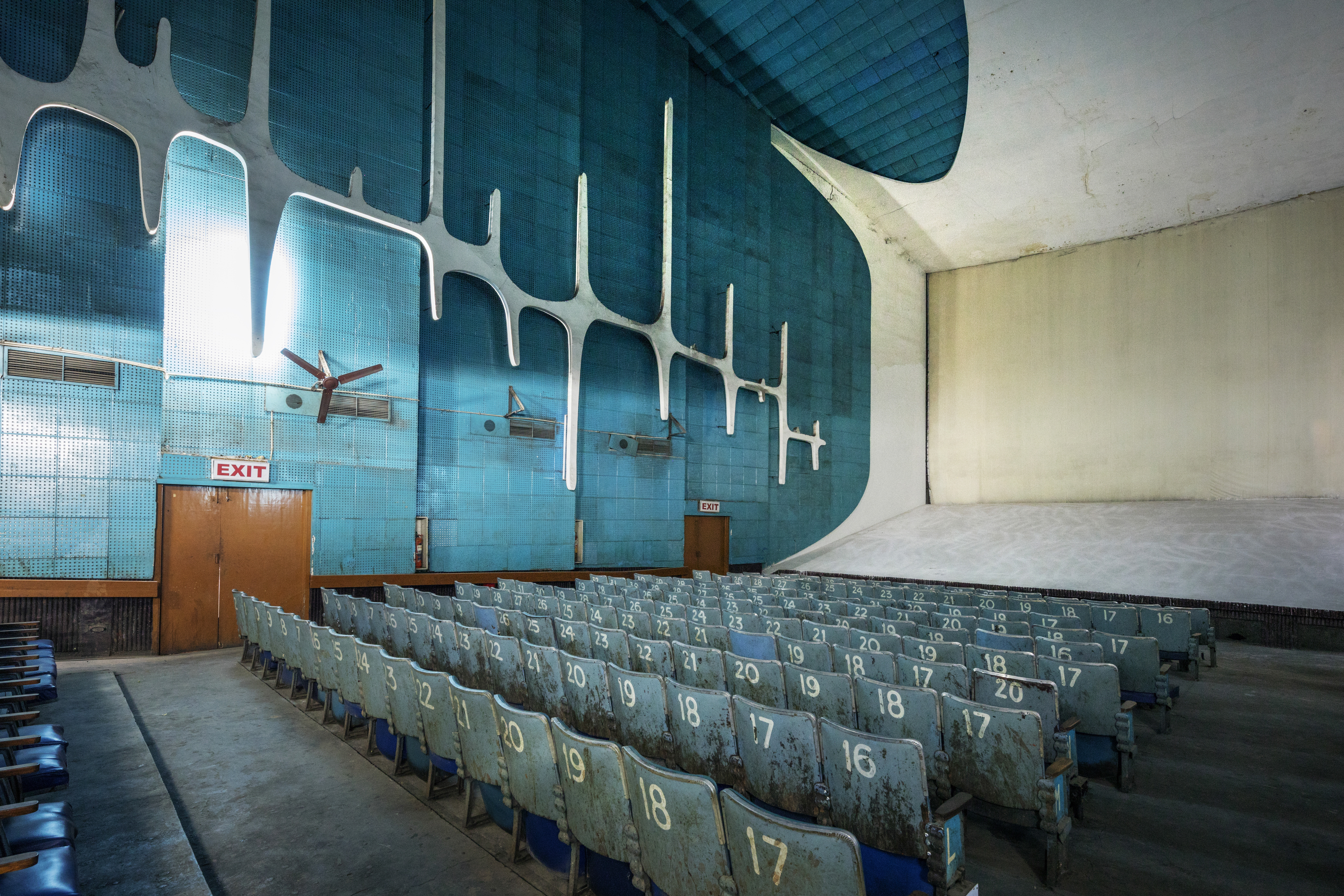 A room used as a cinema with blue walls.