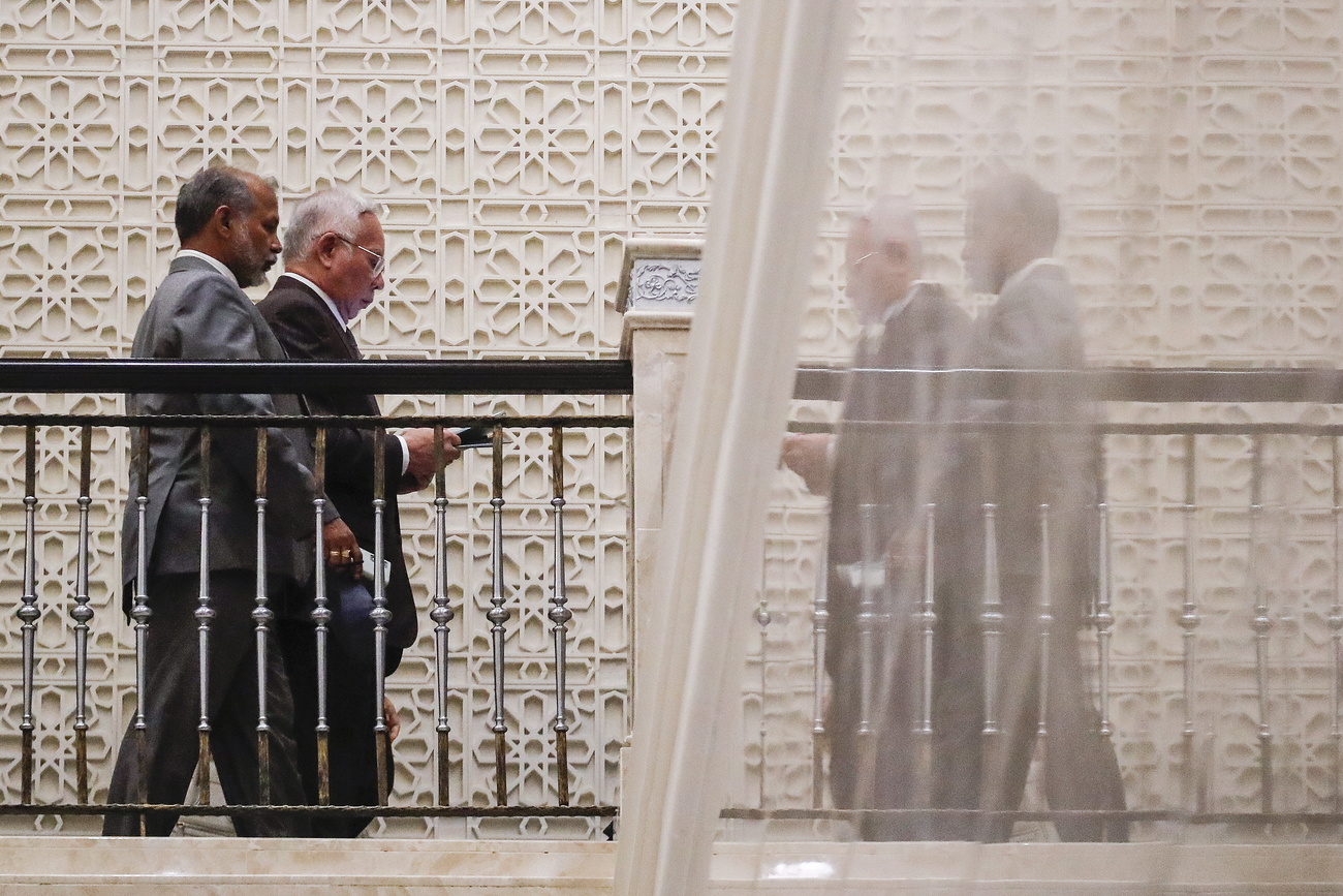 men walking view point from below - with a reflection in a glass oppostite