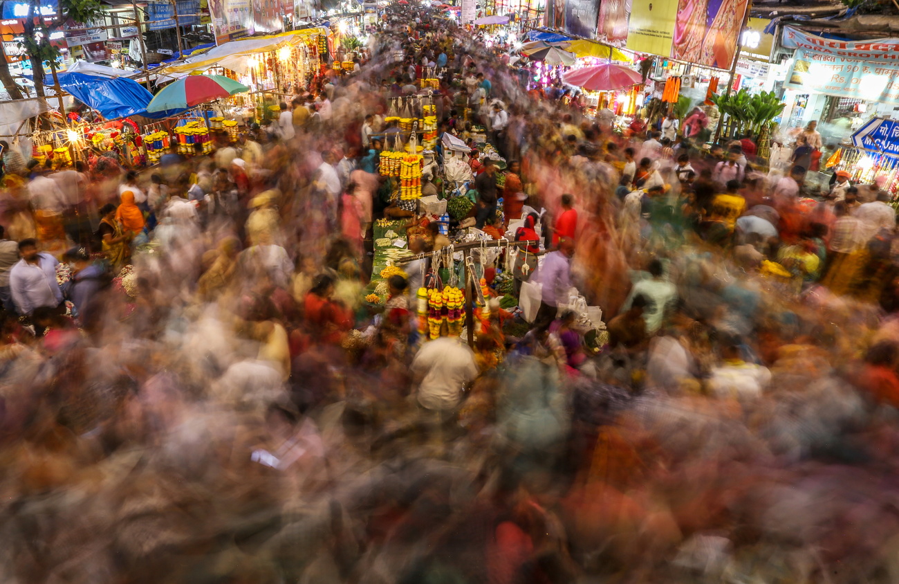 Indian people go shopping at a market ahead of the Ganesh Chaturthi festival in Mumbai, India, 30 August 2022.