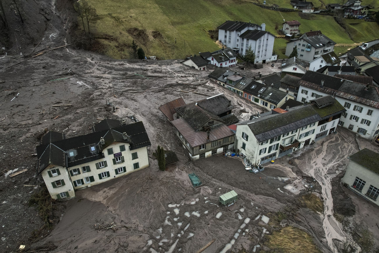 The village of Schwanden following a landslide, houses and buildings enveloped by mud and debris