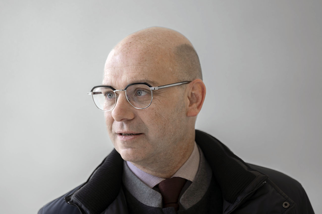 Portrait von Philippe Currat, Brille, dunkler Anzug.