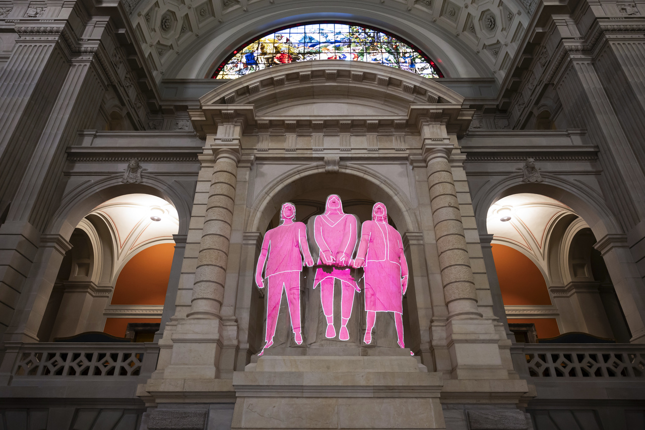 Female figures in the colour pink are projected onto the Three Confederates during an event to mark International Women's Day on Friday, March 8, 2024, at the Federal Palace in Bern.
