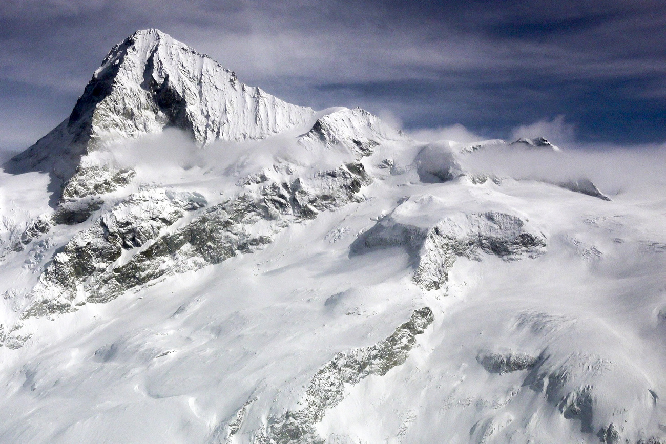 This video still from the video published by the Valais cantonal police on 11 March 2024 shows the Tete Blanche snow field where five bodies were found, center, below the Dent d'Herens mountain, left up, in the Swiss alps mountains, near Sion, Switzerland, Monday, March 11, 2024.