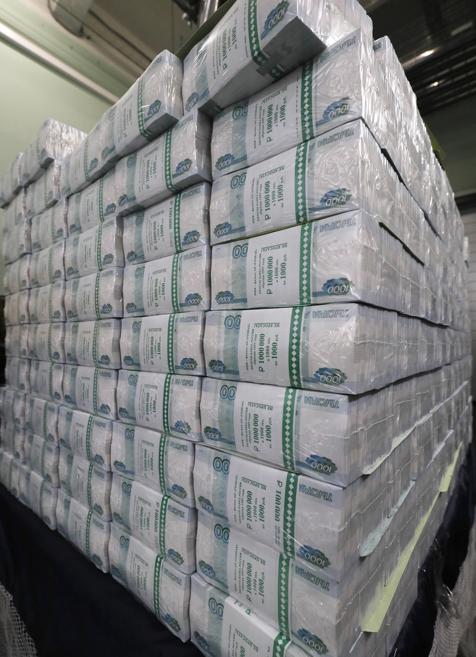 Multiple stacks of Russian banknotes, printed and bound in plastic.