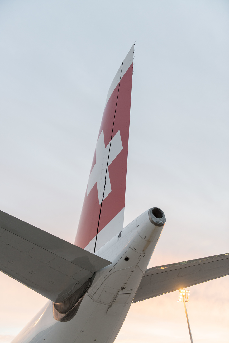 The tail section of an airplane bearing the Swiss Air logo.