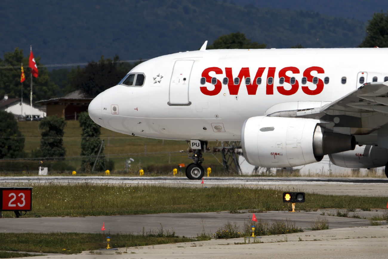 The nose of a SWISS aircraft on a runway, the red lettered ‘SWISS’ logo is visible on the side