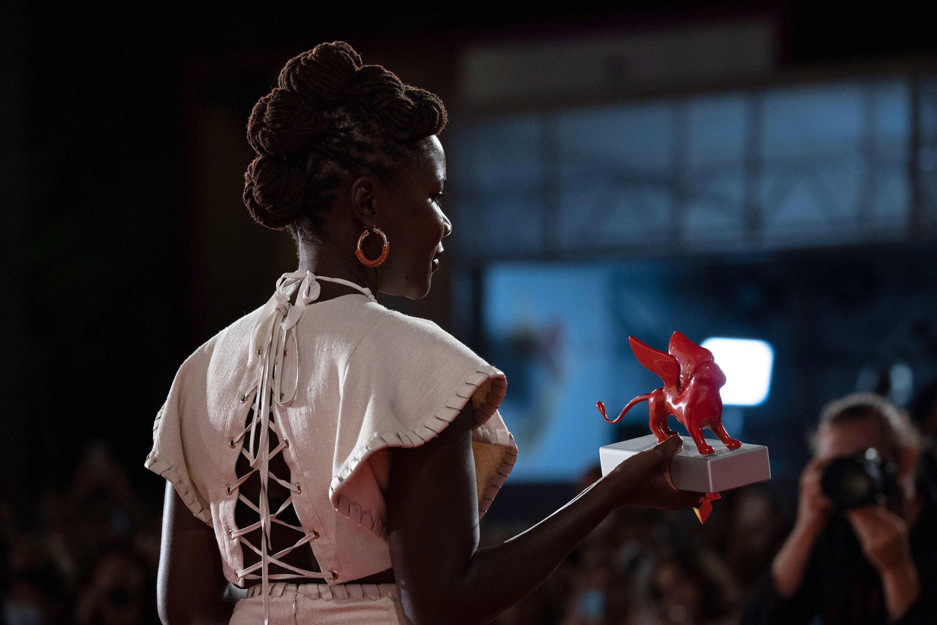 Alice Diop poses with the Lion of the Future  Luigi De Laurentiis Venice Award for a Debut Film for Saint Omer during the award winners photocall