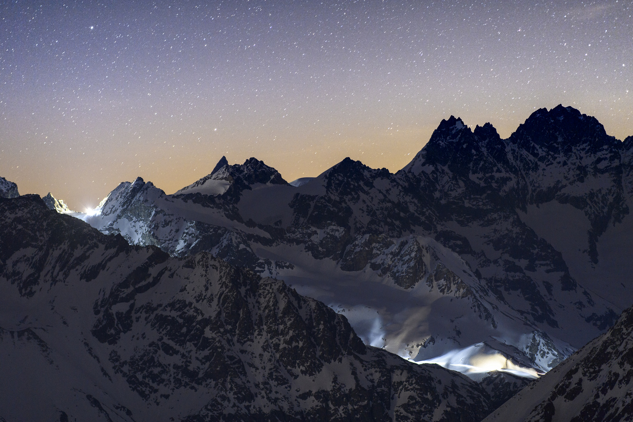 A view of the Swiss alps, with artificially lit sections.