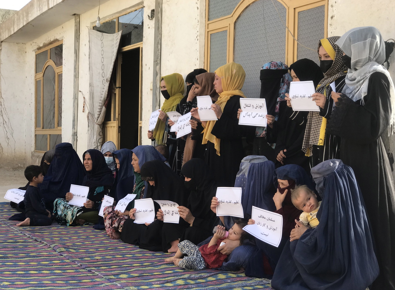 Afghan women and girls protesting against a ban on education and work.