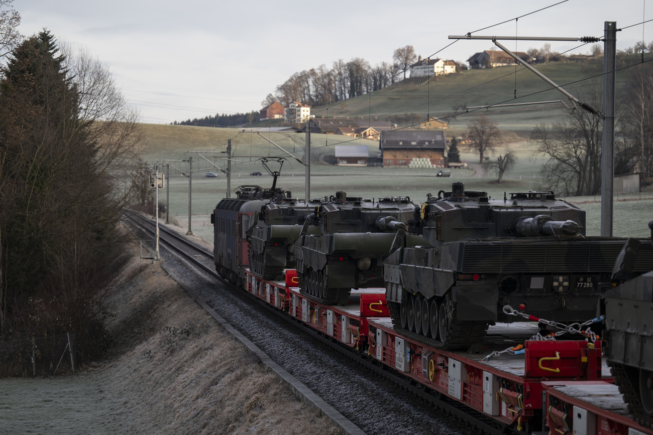 Swiss Army Leopard tanks are transported on a train,