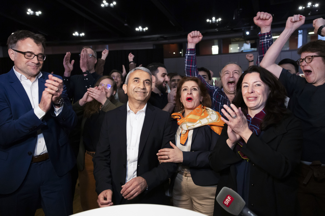 Mustafa Atici (second from left) and his wife Cennet cheer along side their supporters.