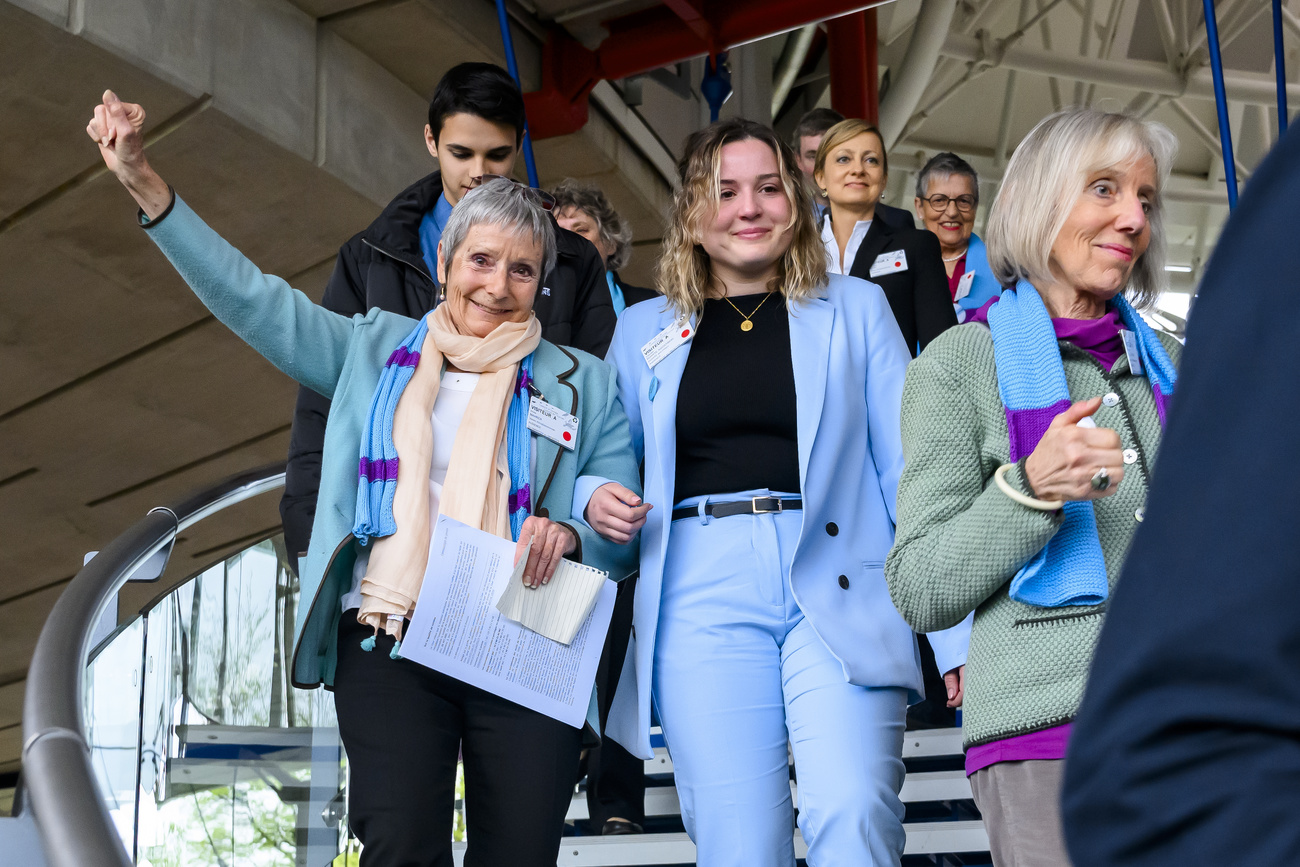 Women wearing blue coming down the staris