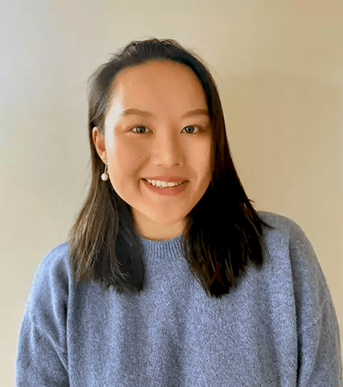 Woman with black hair and a blue sweater.