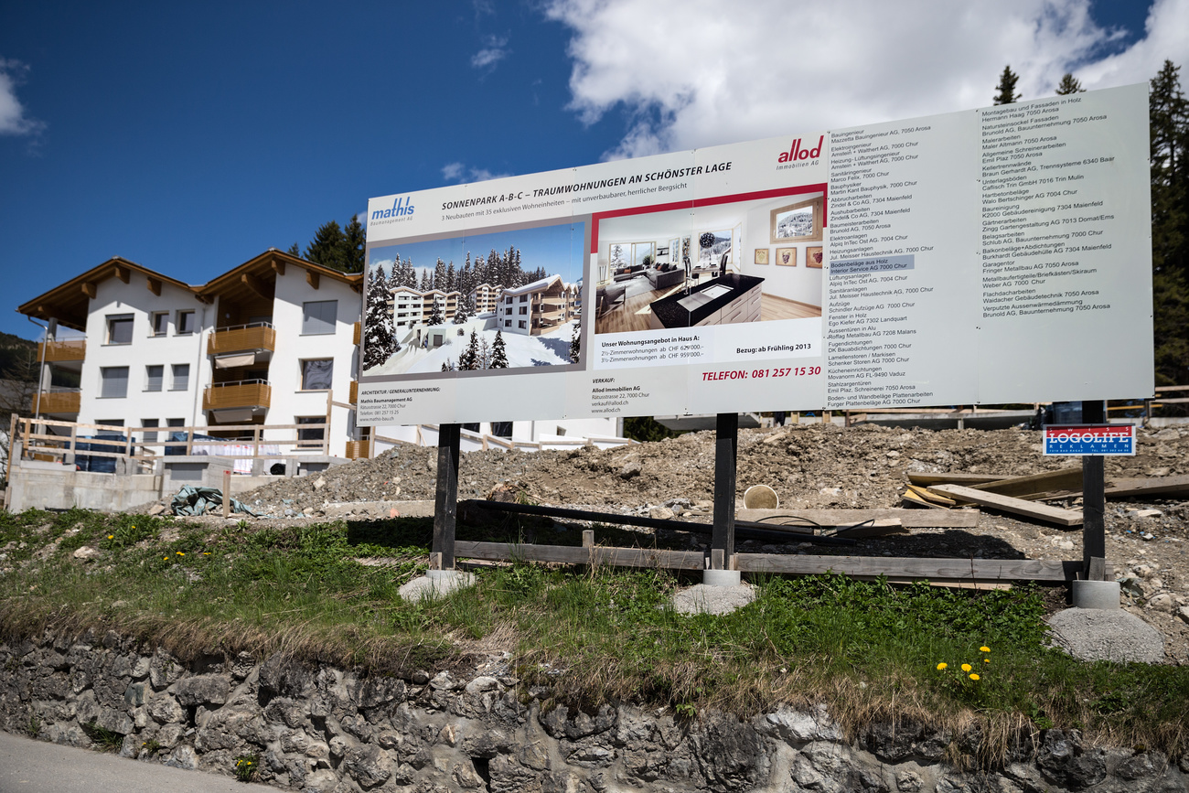A large sign advertises the sale of holiday apartments in Arosa