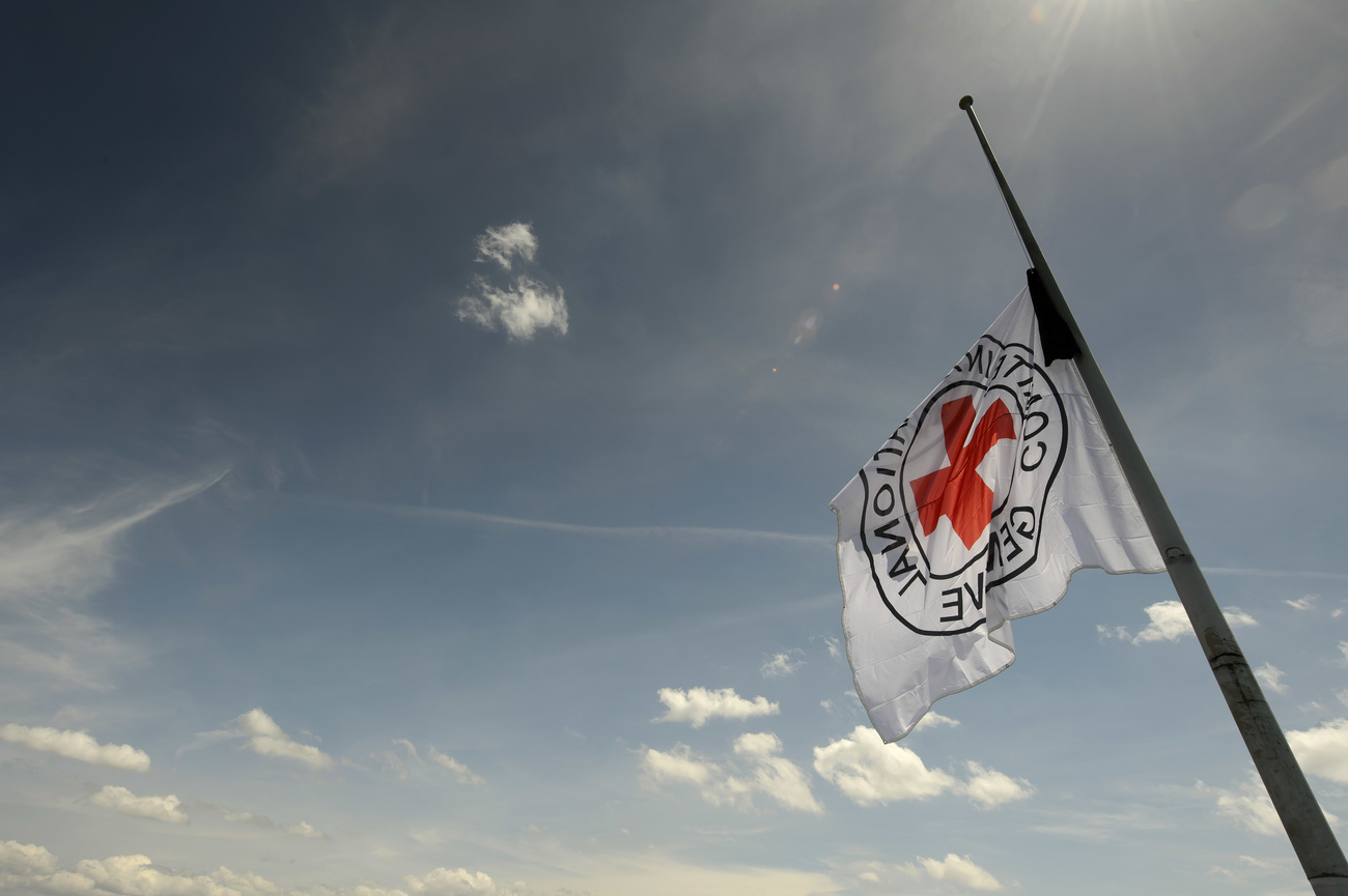 The flag of the Red Cross organisation flying at half mast.