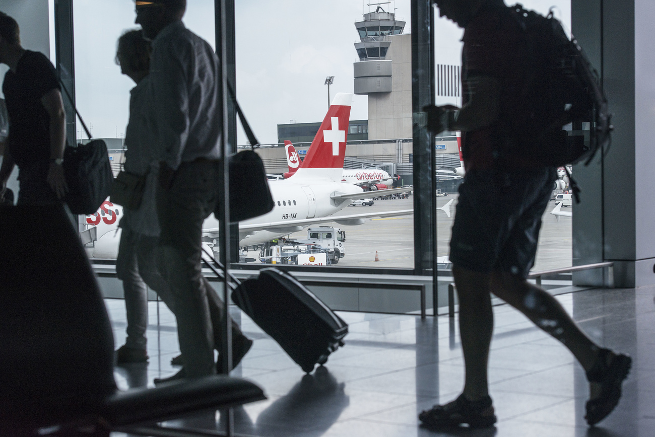 Passengers travel through Zurich Airport.