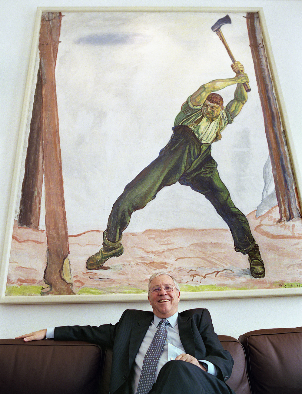 Former Federal Councillor and leader of the right-wing Swiss People's Party Christoph Blocher, posing in his office at the Federal Palace in Bern (2005), with Hodler's The Woodcutter hanging in the background.