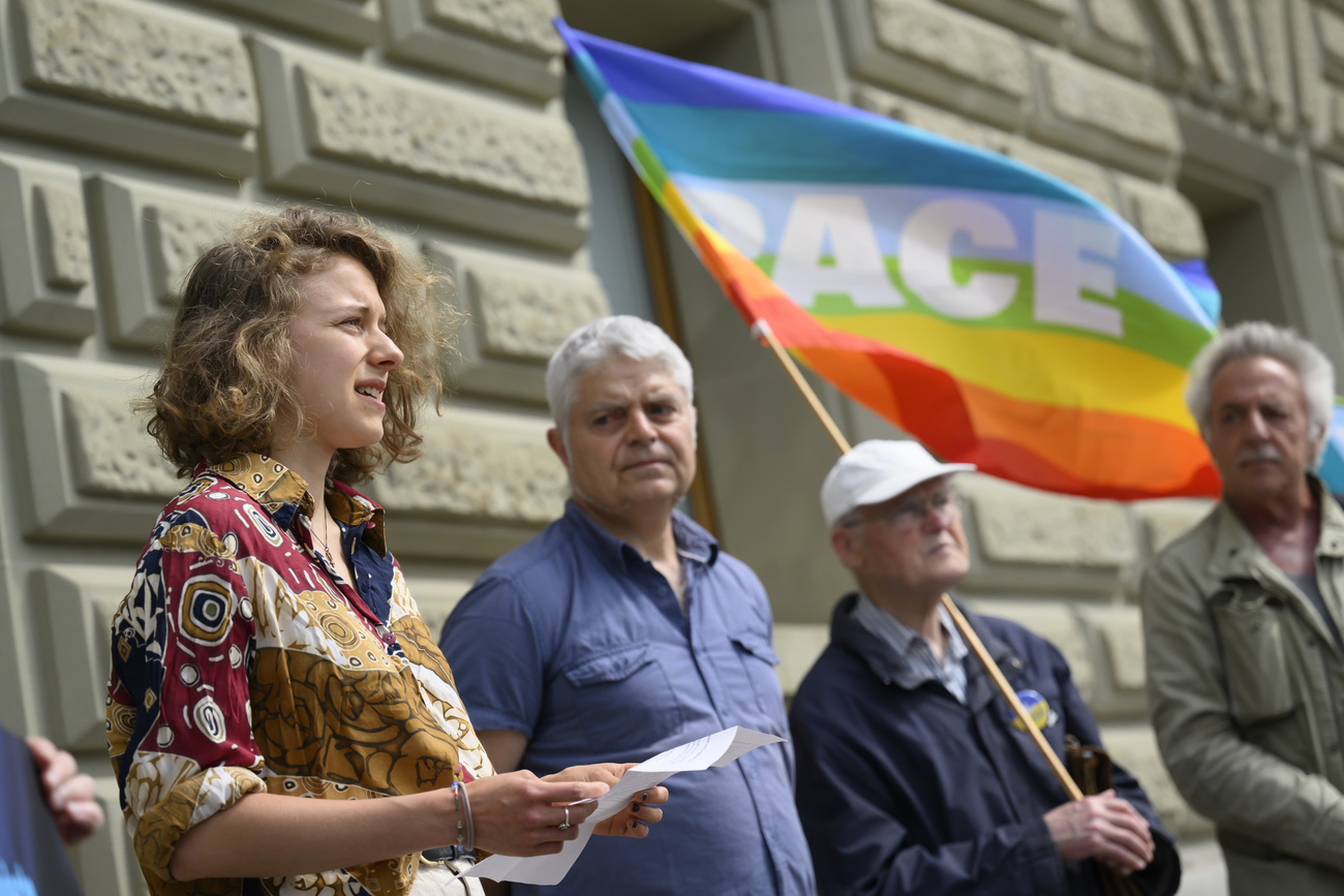 members and supporters of the organisation, Group for a Switzerland without an Army speak in front of the federal parliament building